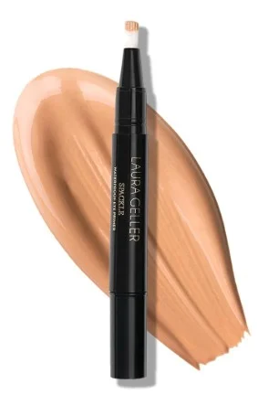 A sleek waterproof eye spackle eye shadow primer by Laura Geller New York positioned beside a smooth swatch of tan colored cream, showcasing its natural finish and ease of application.